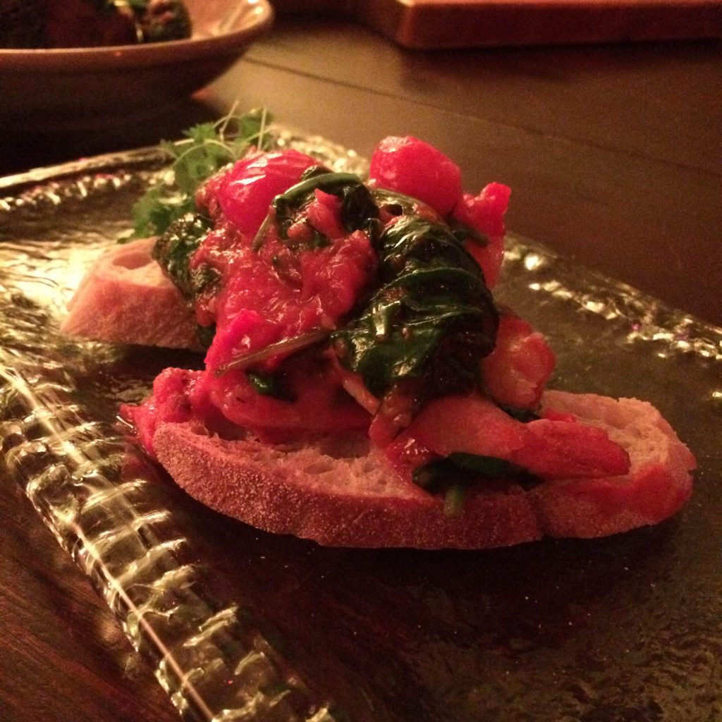 King prawns on bruschetta with roasted cherry tomatoes, garlic and spinach