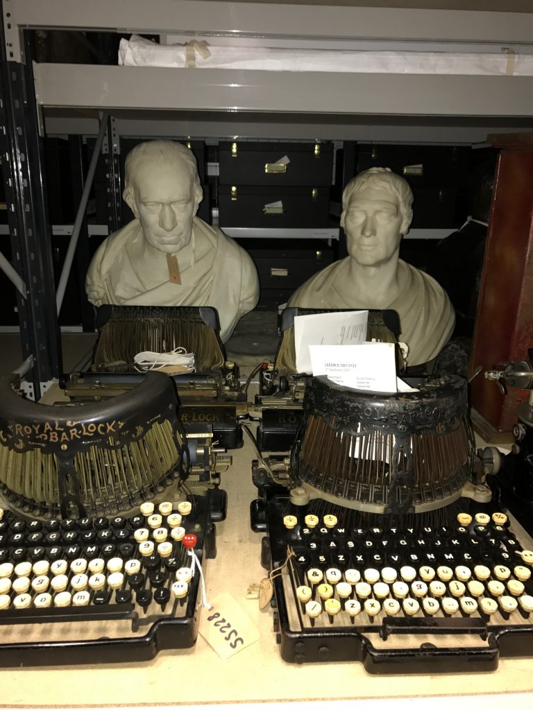 Two heads behind two typewriters